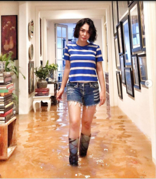 Yuni Shara membenahi rumahnya yang tergenang banjir. Foto: int 