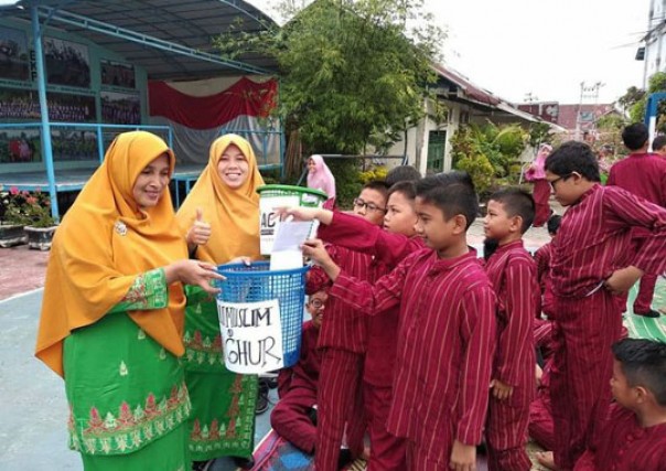 SD Islam As Shofa bersama ACT Riau melakukan kegiatan aksi penggalangan dana./nof