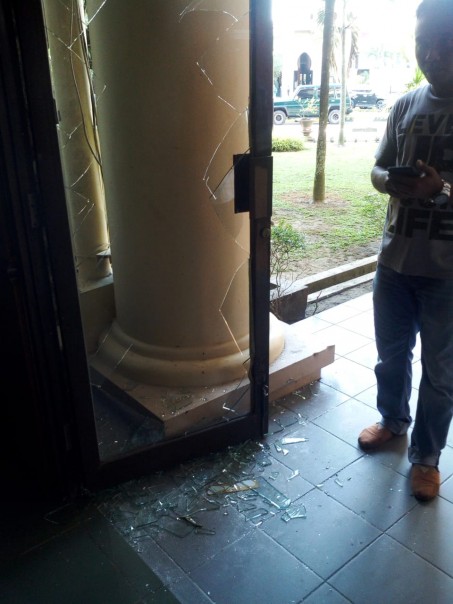 kaca Pintu masuk DPRD Riau pecah karena dirusak oleh oknum mahasiswa yang memaksa ingin masuk
