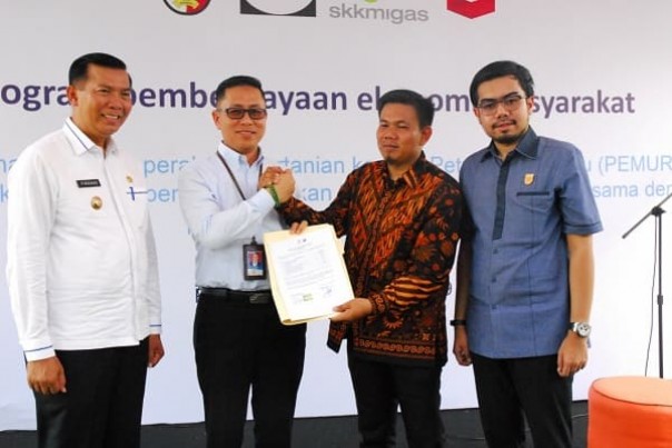 GM Corporate Affairs Asset PT CPI Sukamto Tamrin menyerahkan bantuan kepada Ketua Pemuri disaksikan Walikota Pekanbaru
