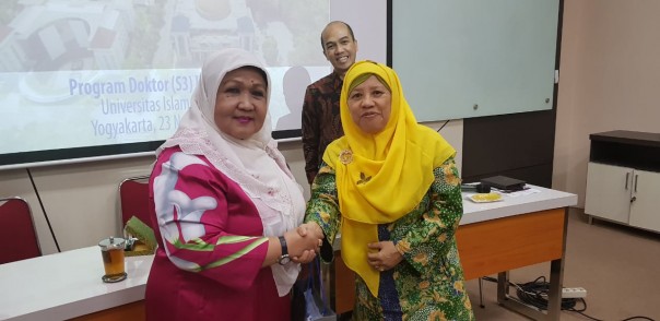 Prof Dr Ellydar Chaidir dan Prof Dr Ni'matul Huda usai bersalaman usai bertukar cenderamata.