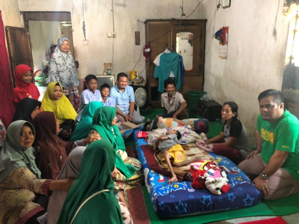 Kepala BPKAD Kuantan Singingi, Hendra, AP, M.Si yang merasa prihatin melihat kondisi bocah Selamat Kurniawan (14) Warga Desa Simandolak (foto/Zar)