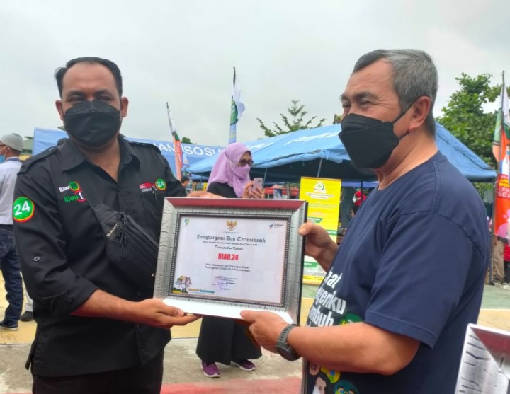 Gubernur Riau Syamsuar serahkan penghargaan pada pimpinan perusahaan Riau24.com Muhardi