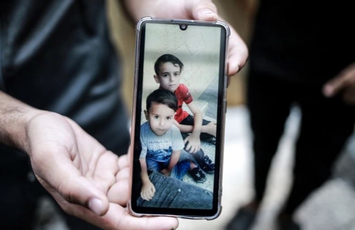 Umm Mohammad al-Nairab, 60, menangis saat menunjukkan gambar cucunya yang terbunuh dalam serangan Israel [Hosam Salem/Al Jazeera]