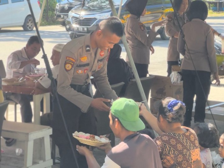 Anggota Samapta Polda Riau melayani masyarakat di tenda makan gratis dekat RTH Jalan Ahmad Yani