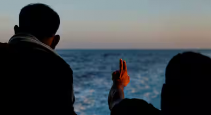 Foto dari 30 September 2023 ini, seorang migran memberi isyarat di kapal penyelamat migran Geo Barents saat menuju Italia setelah penyelamatan 61 migran di atas kapal kayu di perairan internasional di lepas pantai Libya di Laut Mediterania tengah /Reuters