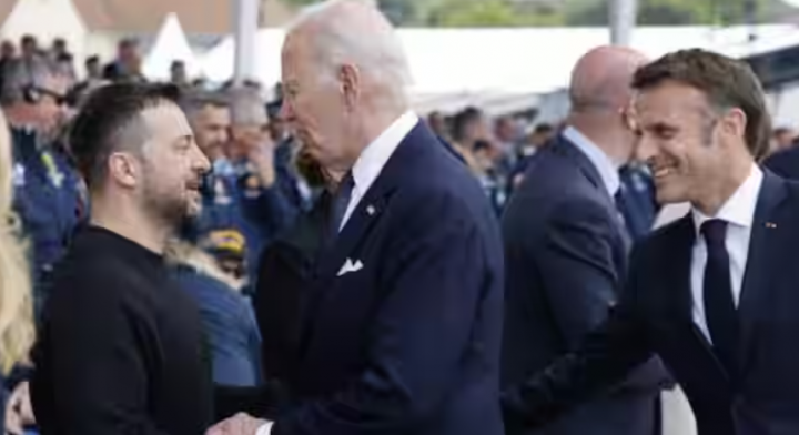 Presiden AS Joe Biden (kanan) berjabat tangan dengan Presiden Ukraina Volodymyr Zelensky (kiri) saat Presiden Prancis Emmanuel Macron (kanan) menyaksikan selama upacara peringatan Internasional di Pantai Omaha menandai peringatan 80 tahun pendaratan Sekutu 'D-Day' Perang Dunia II di Normandia, di Sa